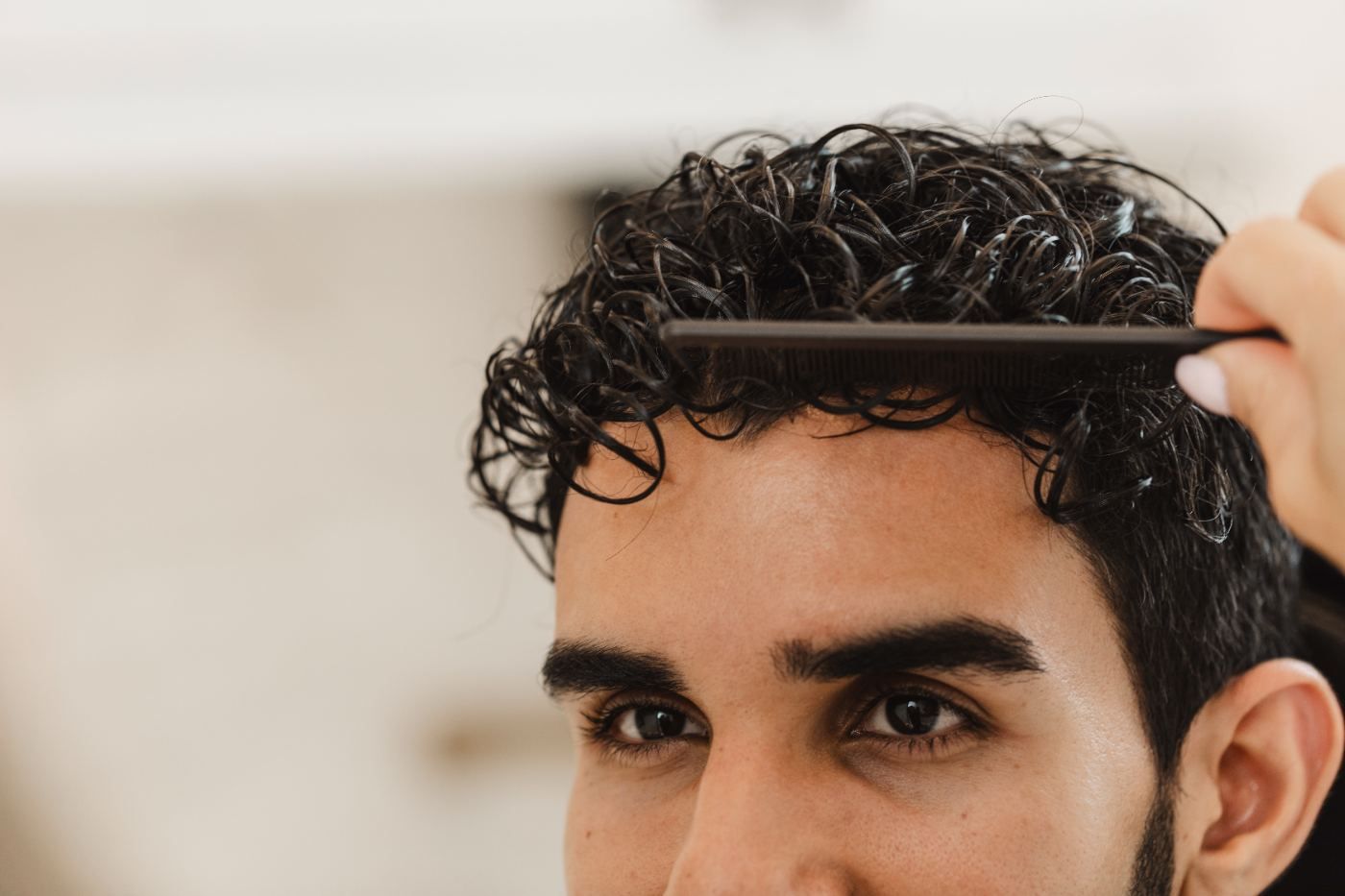 Close-up of a man combing his hair